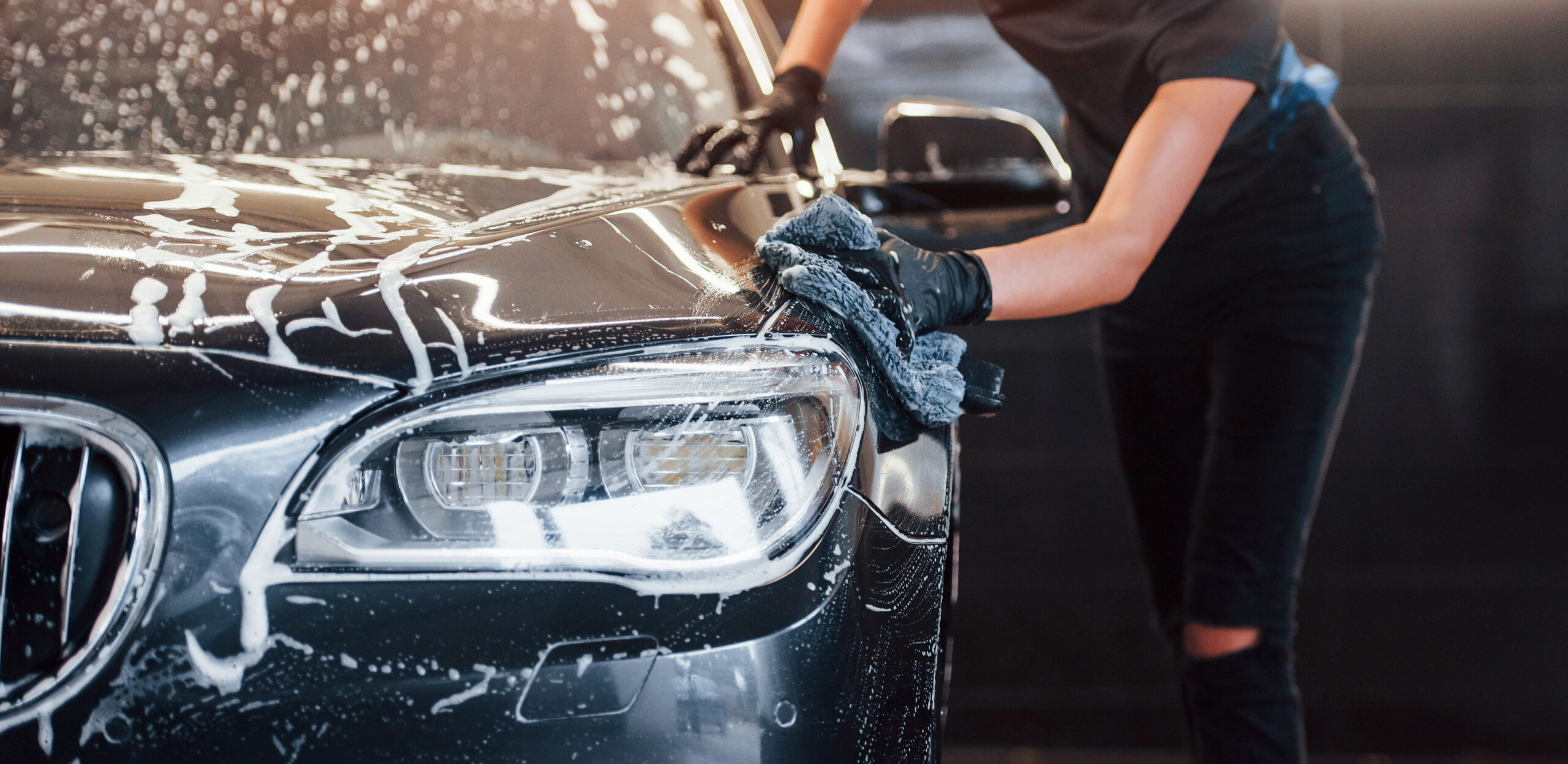 Bravus technician hand washing a vehicle in Fairfax VA