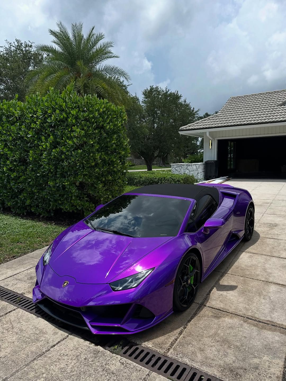 Purple Lamborghini Huracan with doors open after professional detailing