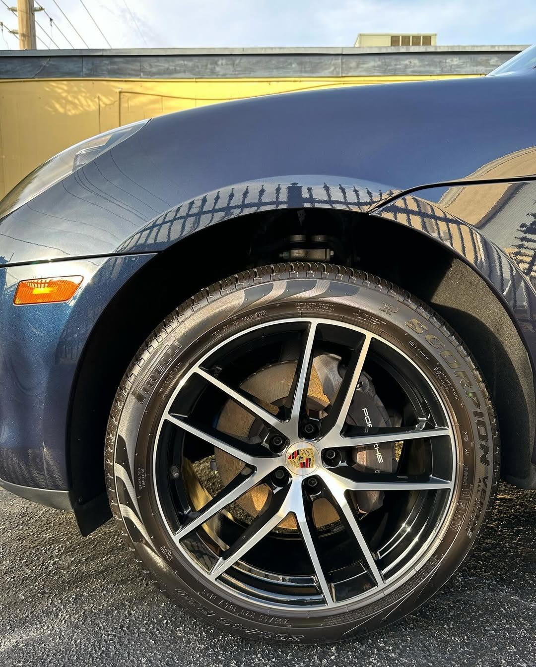 Detailed wheel with gold brake calipers on a premium car